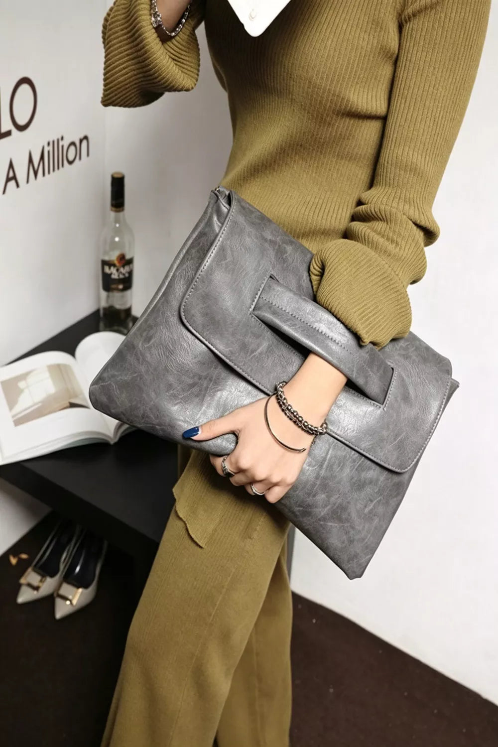 Timeless Envelope Clutch in distressed light gray leather with cut-out handle detail.