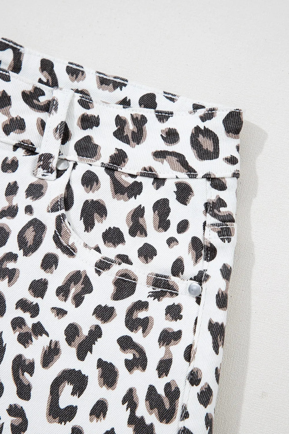 Leopard print denim shorts with frayed hem detail