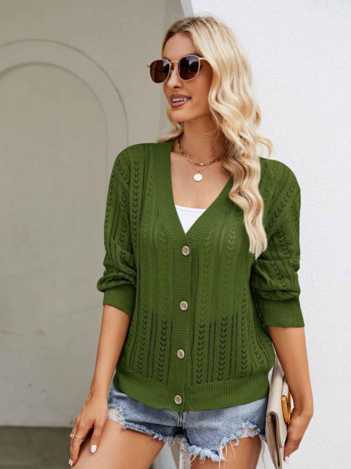 Army green ribbed trim cardigan with button front and open knit detail.