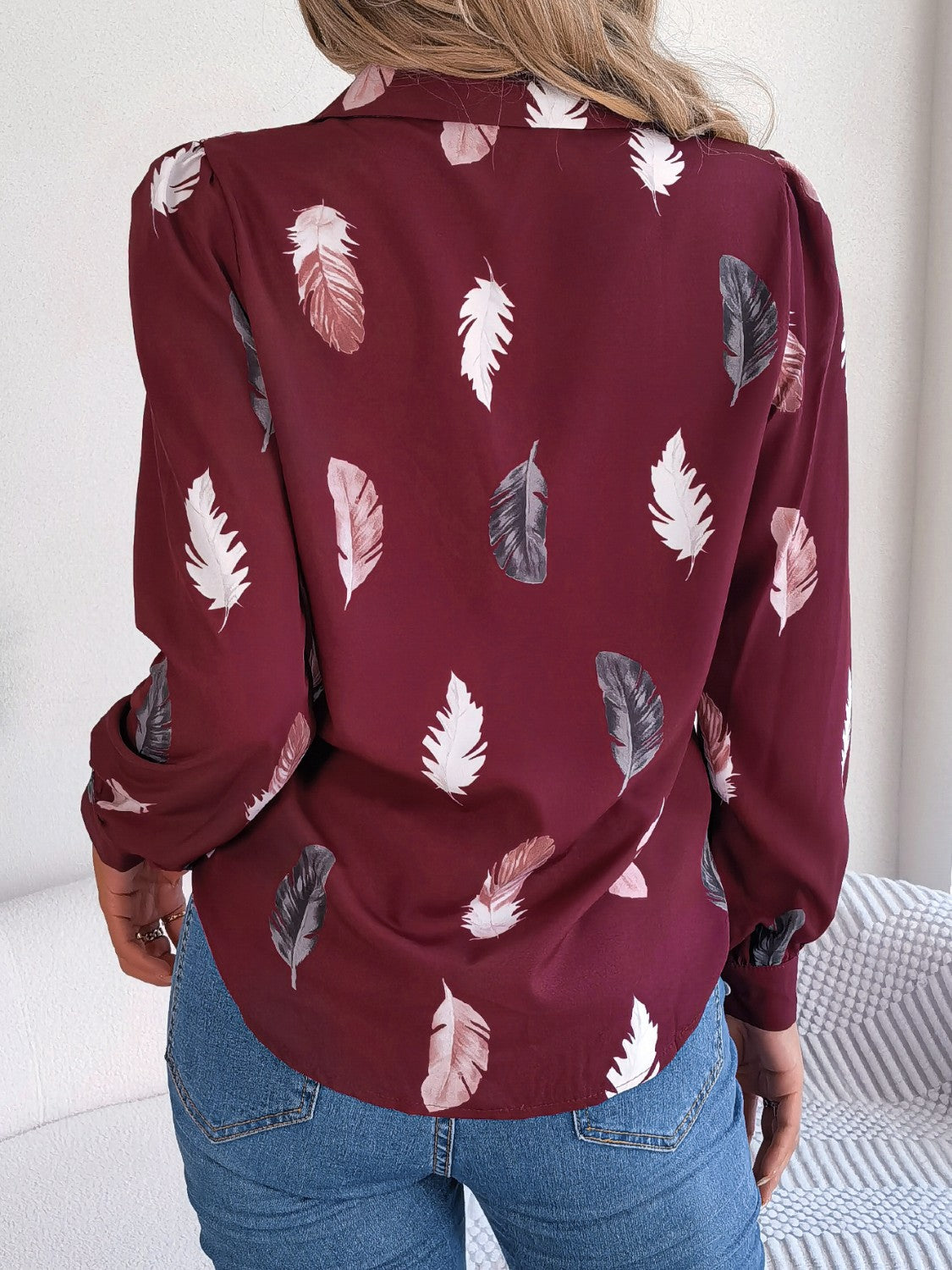 Wine feather print blouson sleeve shirt with button-down collar.