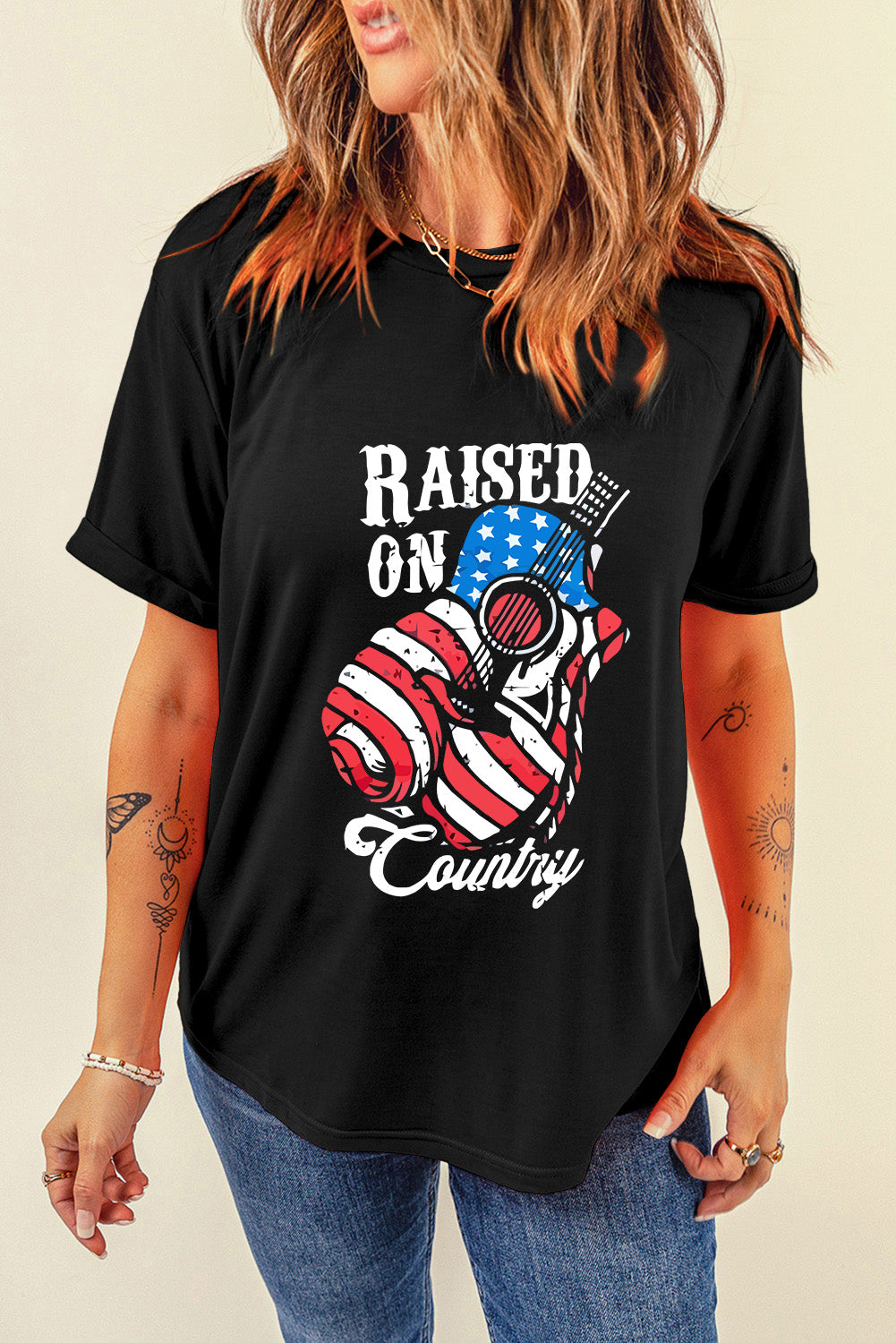 Black t-shirt with Raised On Country graphic featuring an American flag guitar.