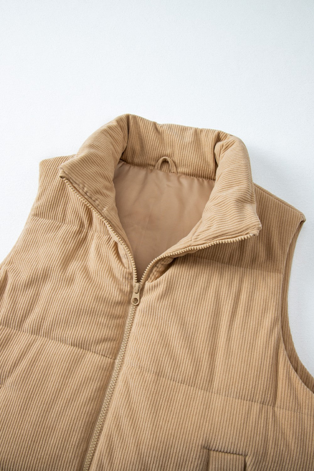 Tan corduroy padded funnel neck vest with a zipper closure.