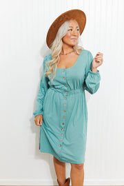 Button-down empire waist mini dress in teal with long sleeves and elastic waist