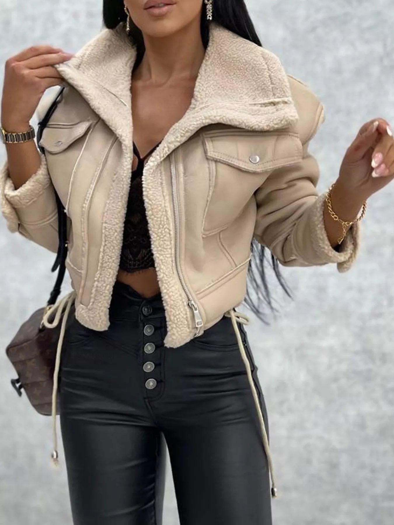 Beige cropped sherpa trim jacket with zip front and chest pockets.