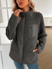 Dark gray teddy fleece jacket with zip closure and patch pocket detail.