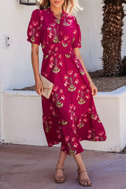 Charming floral tiered midi dress in magenta with short sleeves and a ruffled neckline.