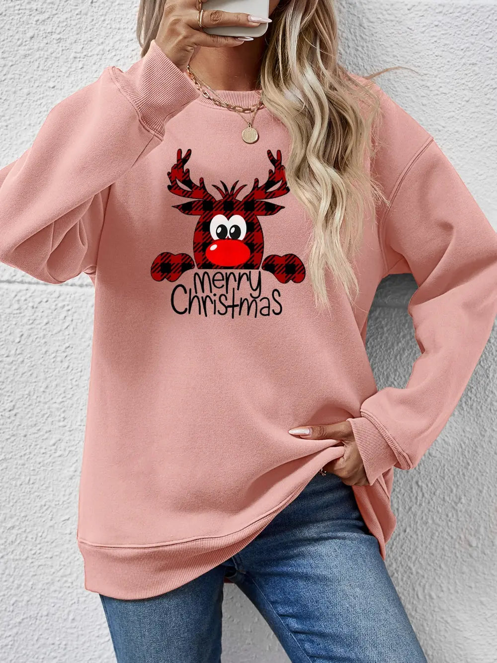Plaid reindeer graphic crewneck sweatshirt in blush pink with Merry Christmas text.