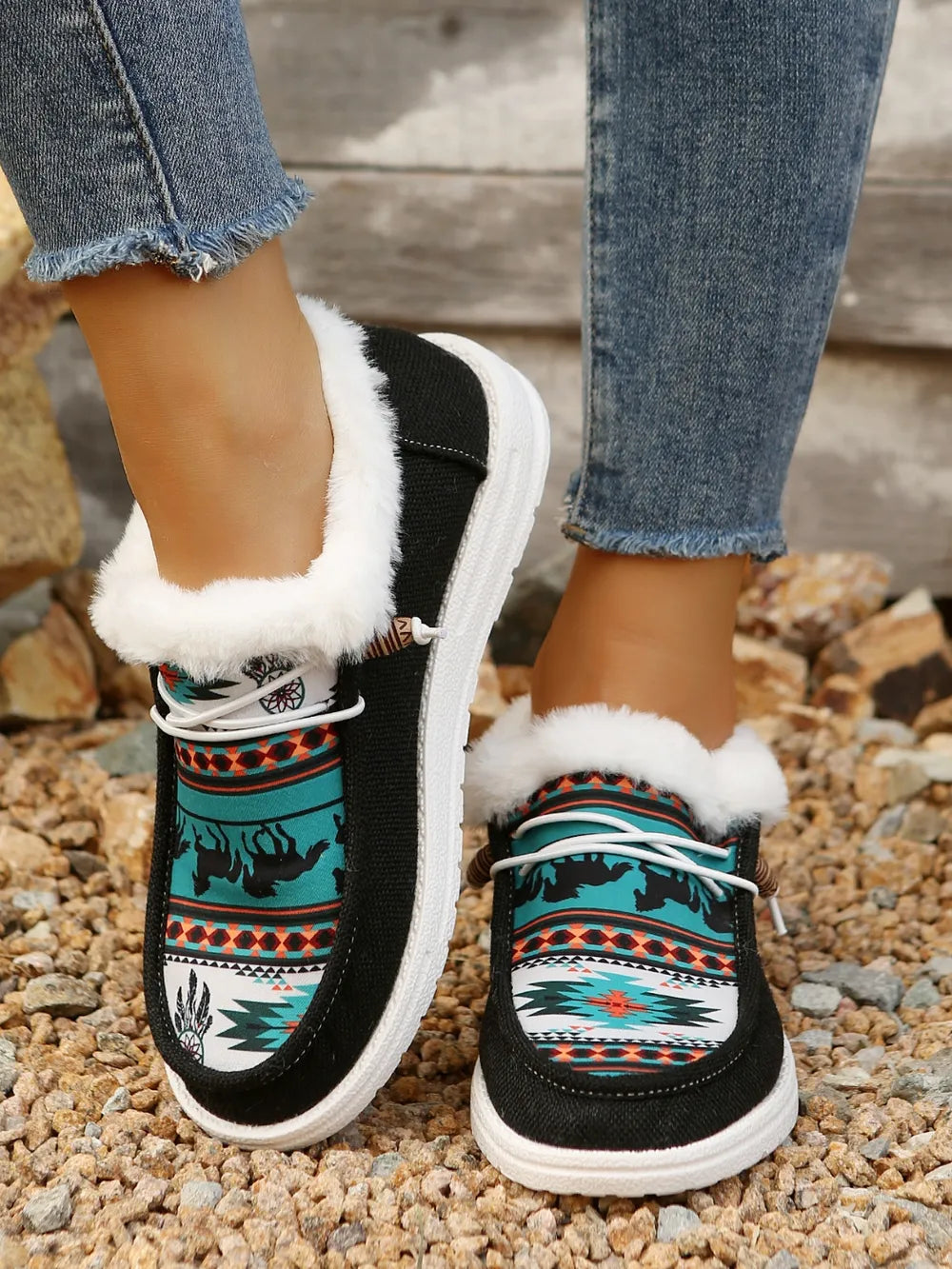 Black Southwestern print faux fur lined loafers with white laces and soles.