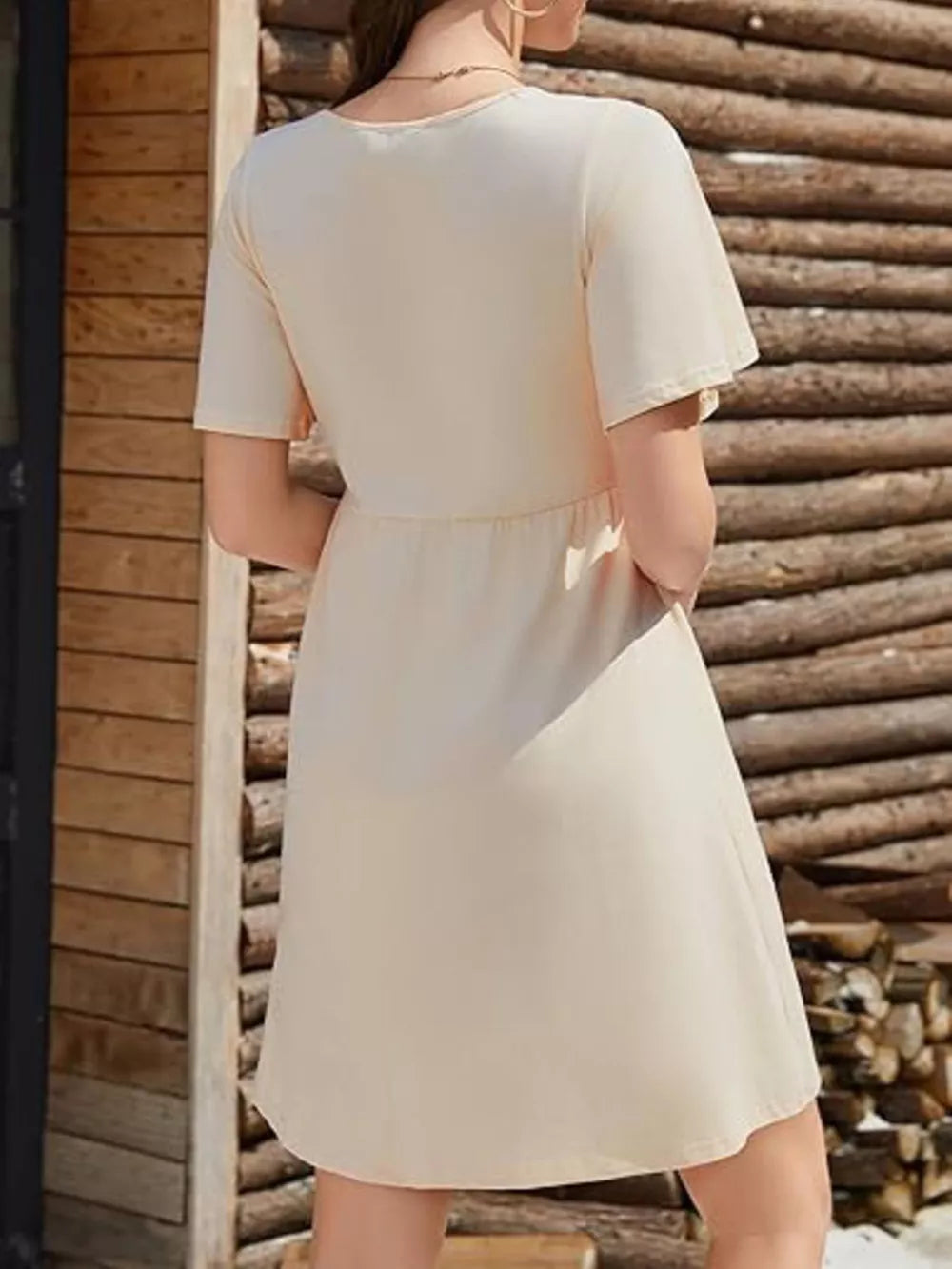 Khaki cotton V-neck mini dress with short sleeves and a cinched waist.