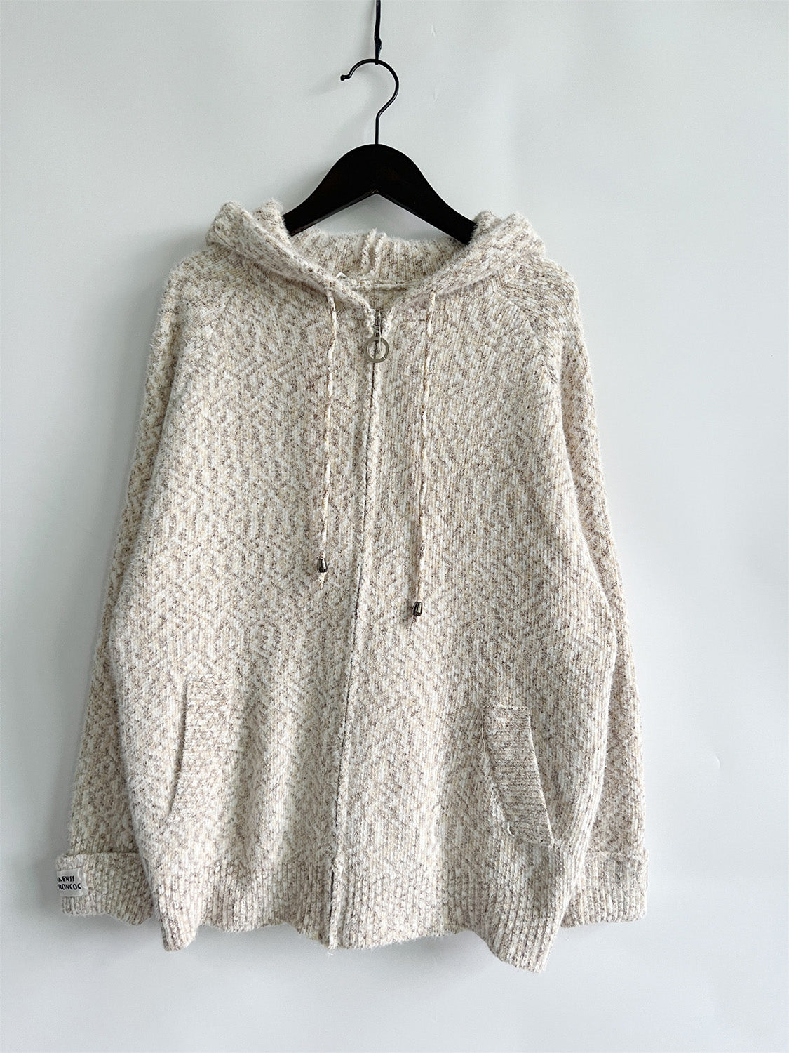 Speckled knit relaxed zip-up hoodie in a light neutral tone with a herringbone pattern.