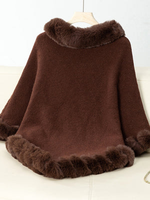 Chocolate knit poncho with faux fur trim at neckline and hem.