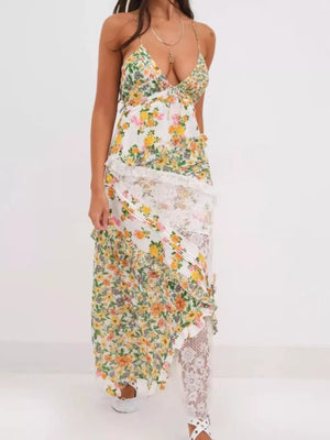 Maxi dress with floral print, lace trim, and asymmetrical ruffles.