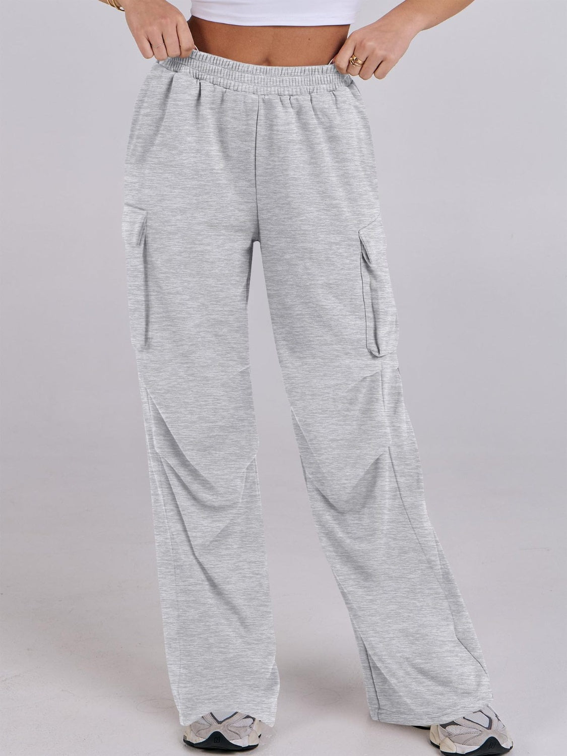 Light gray sweatpants with cargo pockets and a wide leg fit.