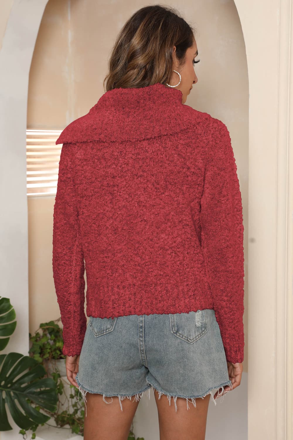 Deep Red textured knit sweater with asymmetric collar and long sleeves.