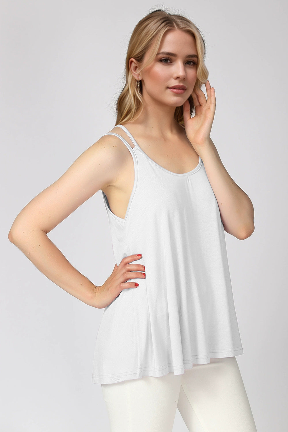White double strap trapeze cami with a relaxed fit and scoop neckline.