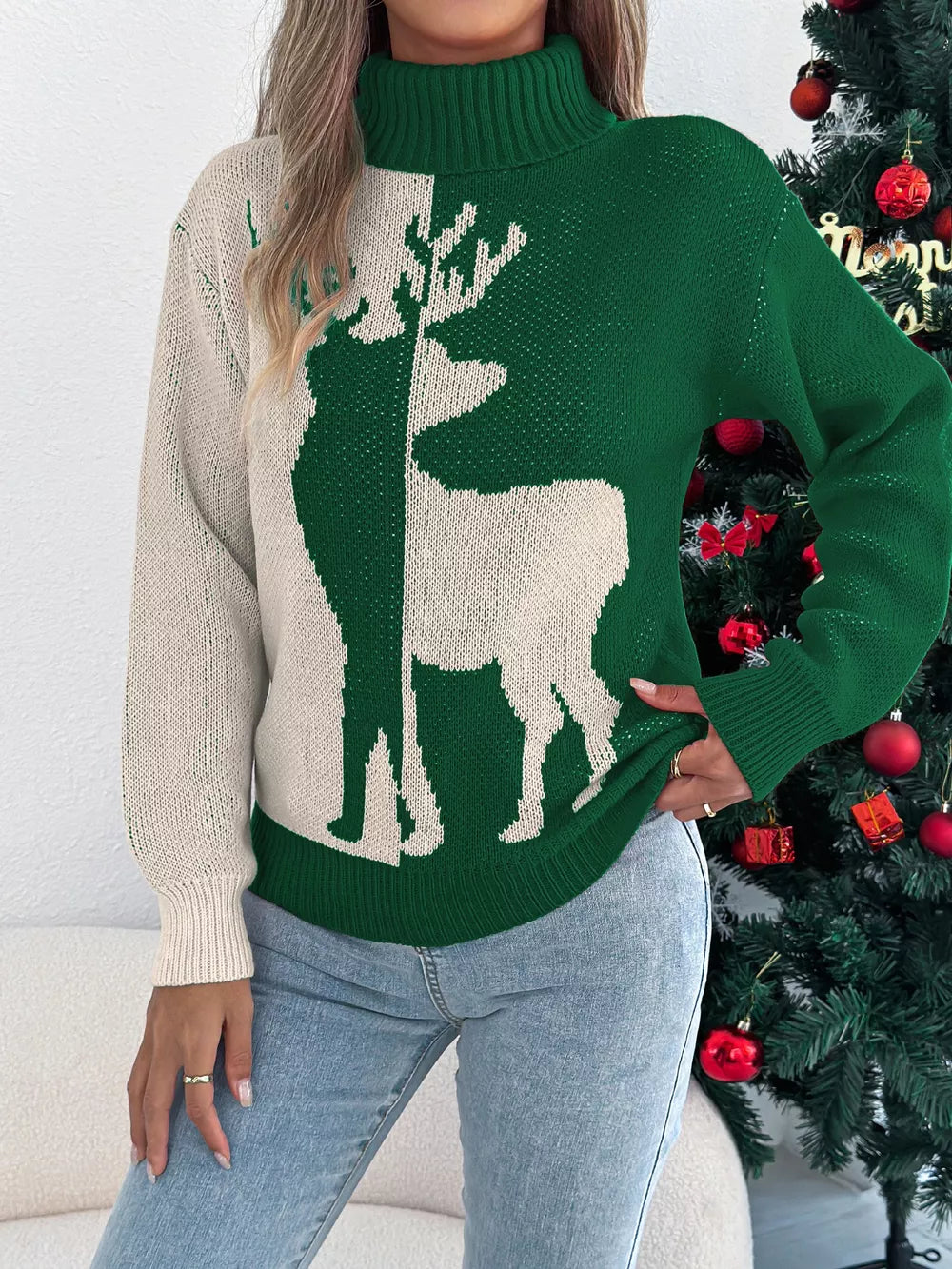 Green and cream knit turtleneck sweater with reindeer graphic, long sleeves, and ribbed trim.