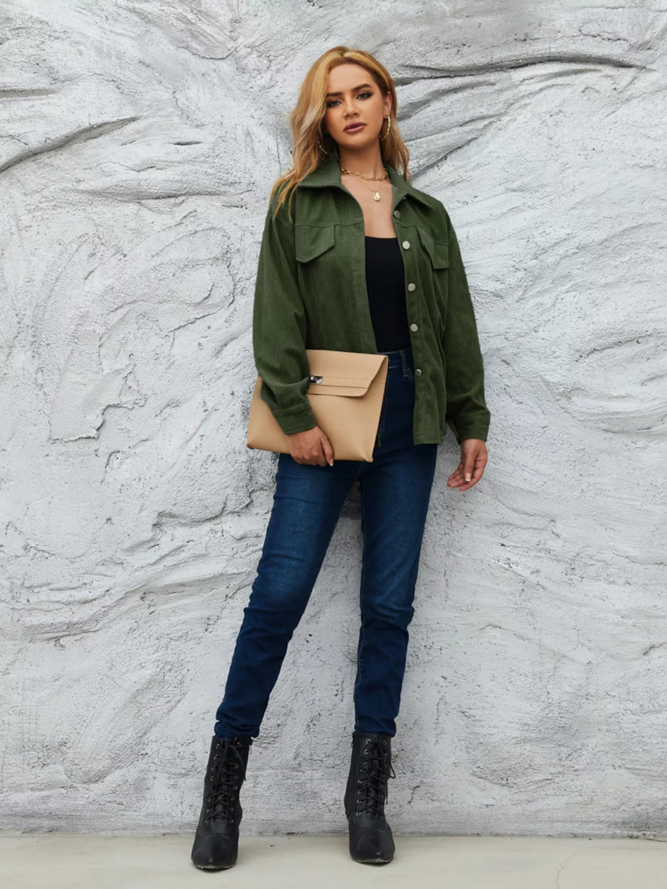 Olive green corduroy button-up jacket with two chest pockets and a collared neckline.
