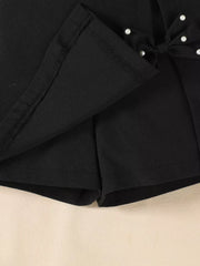Black baby skort set with pearl-embellished bow detail