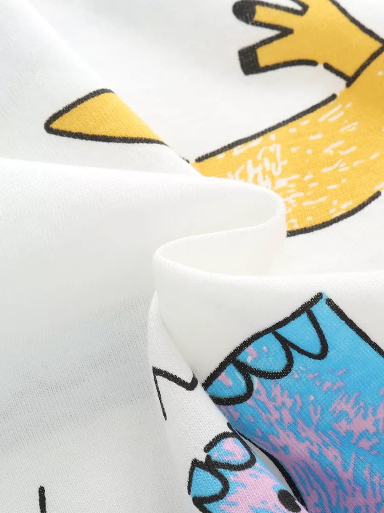 White cotton t-shirt with a cartoon dinosaur graphic and round neck.