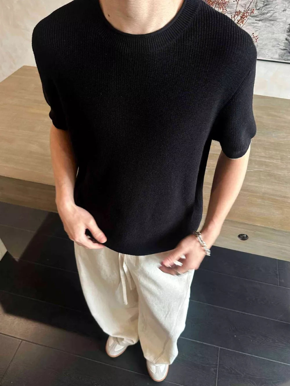 Black short sleeve knit undershirt with crew neck.