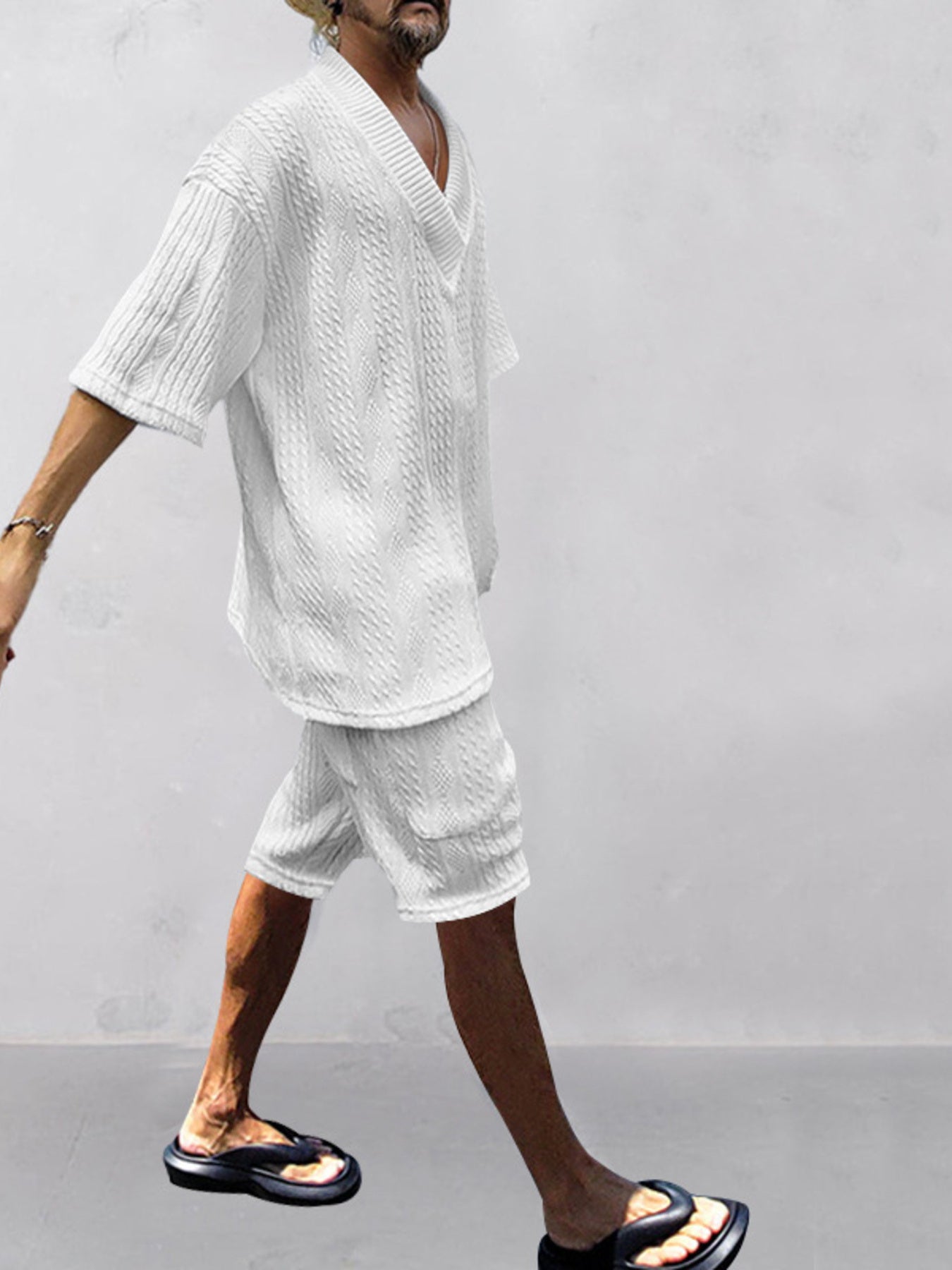 White cable-knit V-neck two-piece set with short sleeves and shorts.