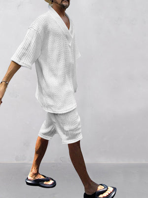 White cable-knit V-neck two-piece set with short sleeves and shorts.