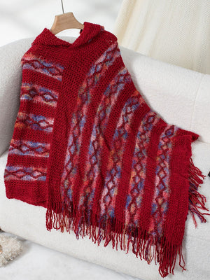 Red hooded knit cape with fringe and diamond pattern, acrylic.