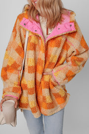 Checkerboard sherpa jacket in tangerine with contrast pink collar and trim.
