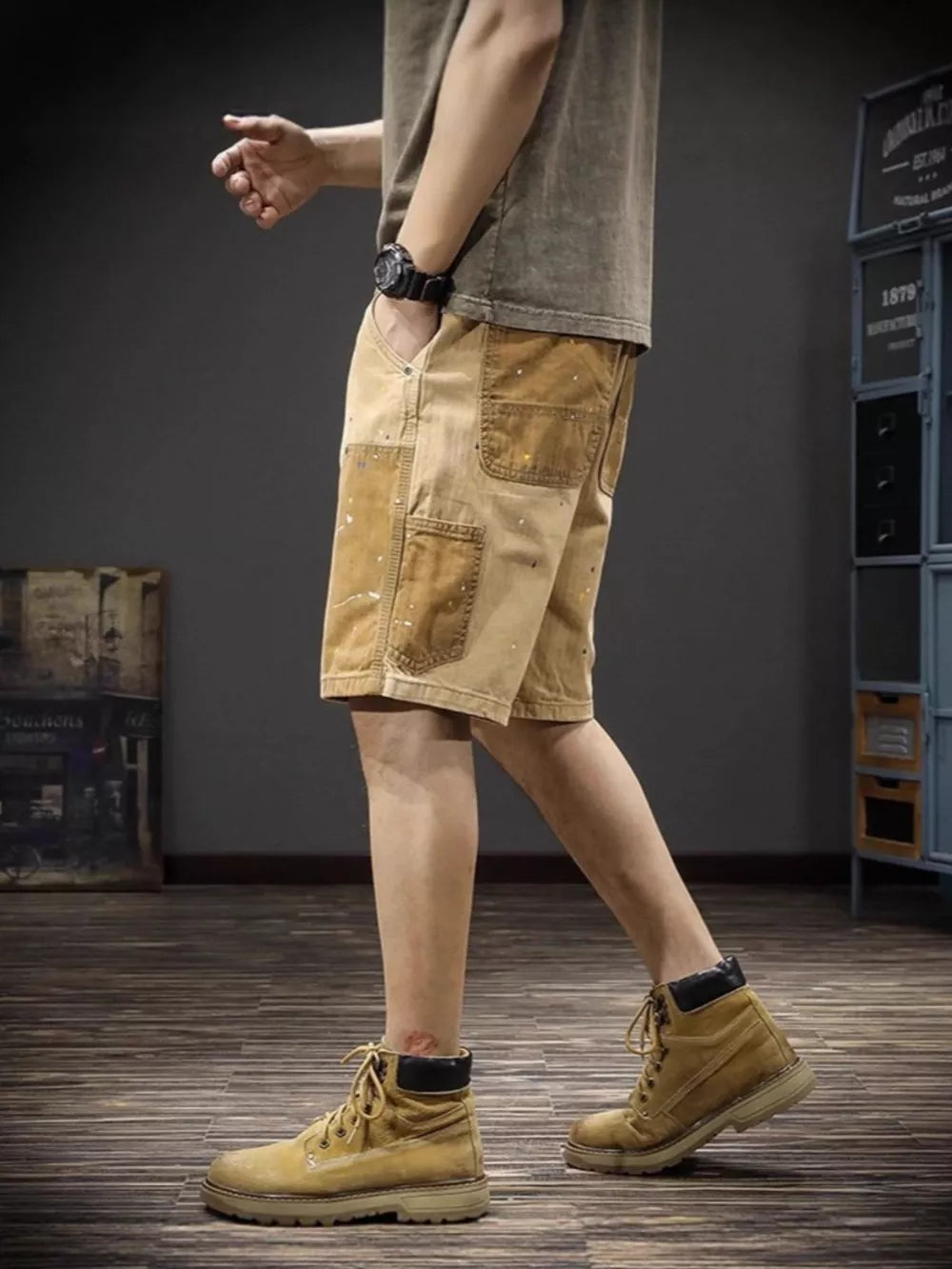Artistic cargo shorts in tan with paint splatters and multiple pockets.
