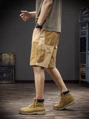 Artistic cargo shorts in tan with paint splatters and multiple pockets.