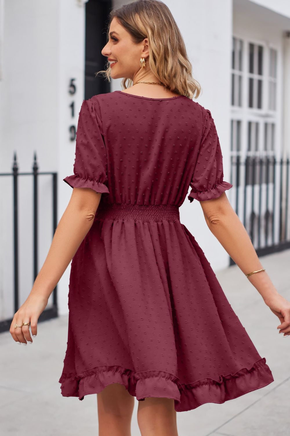 Burgundy textured dot puff sleeve fit-and-flare dress with smocked waist and ruffled hem.