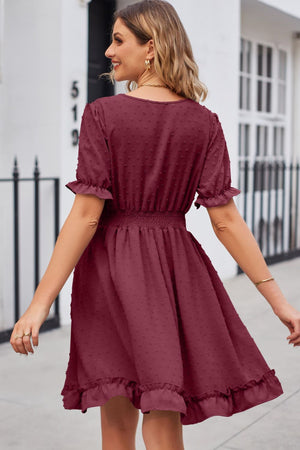 Burgundy textured dot puff sleeve fit-and-flare dress with smocked waist and ruffled hem.