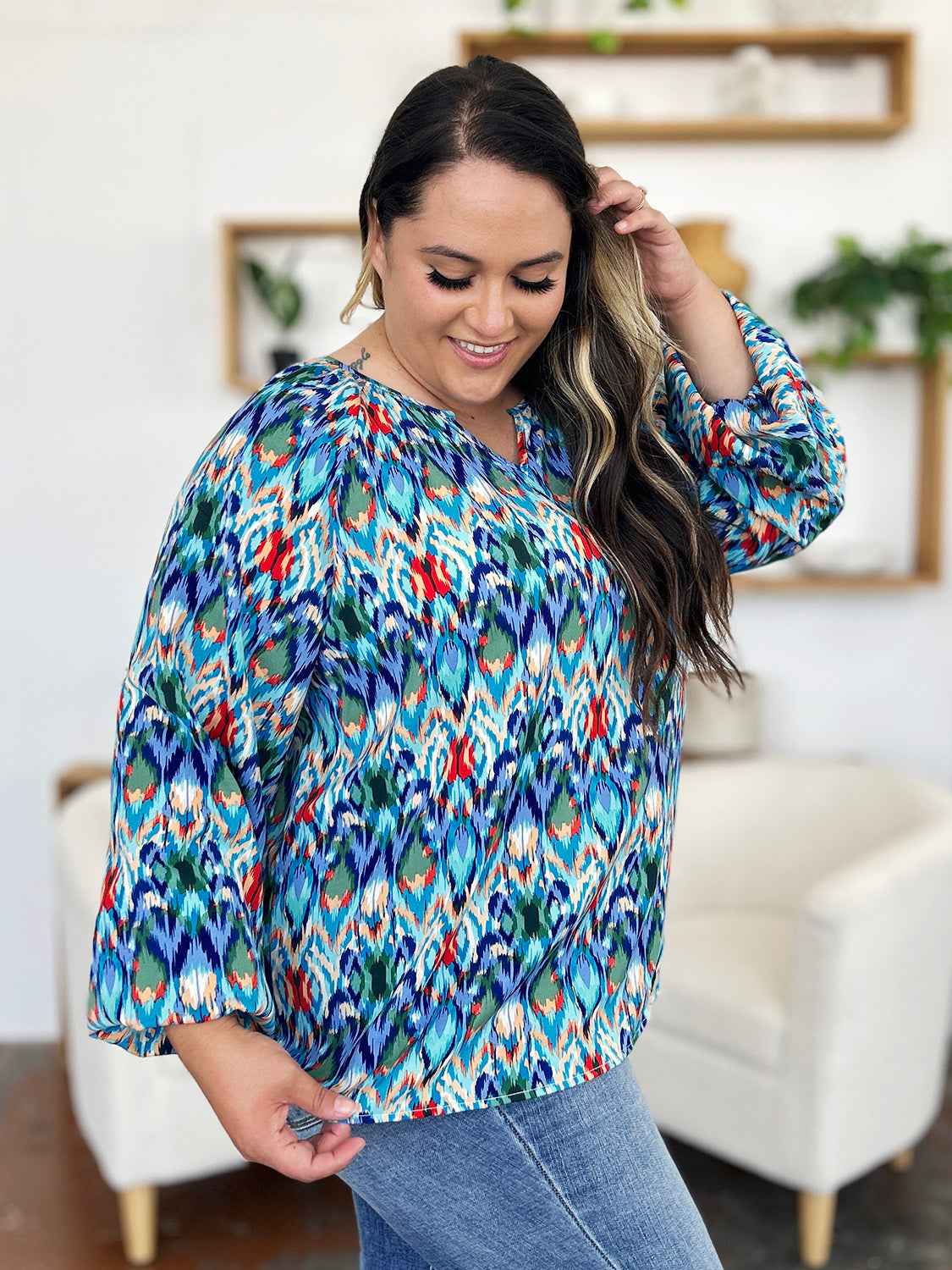 Prismatic ikat blouse in blue with voluminous sleeves and a V-neck.