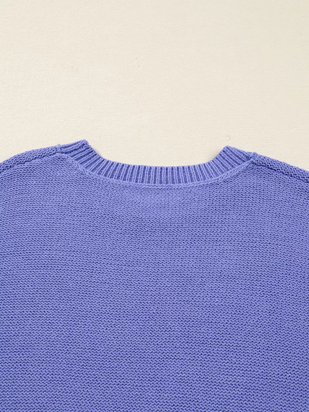 Plus size lavender knit sweater with crew neck and ribbed trim.