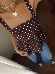 Brown polka dot tie-back cami with ruffled hem, paired with jeans.