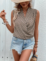 Geometric print draped sleeveless blouse in tan with a V-neckline.