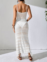 White crochet maxi dress with fringe hem and open knit details.
