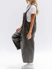 Ripped relaxed fit denim overalls in dark blue with distressed details and adjustable straps.