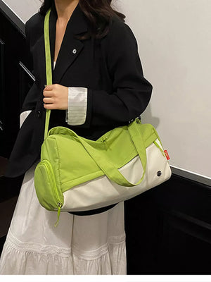 Vibrant color-block nylon travel bag with green and white panels and a zippered side pocket.