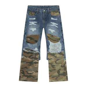 Distressed wide-leg jeans with camouflage panels and rips in medium blue denim.