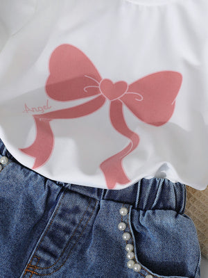 White tee with pink bow print and pearl-trimmed denim shorts.