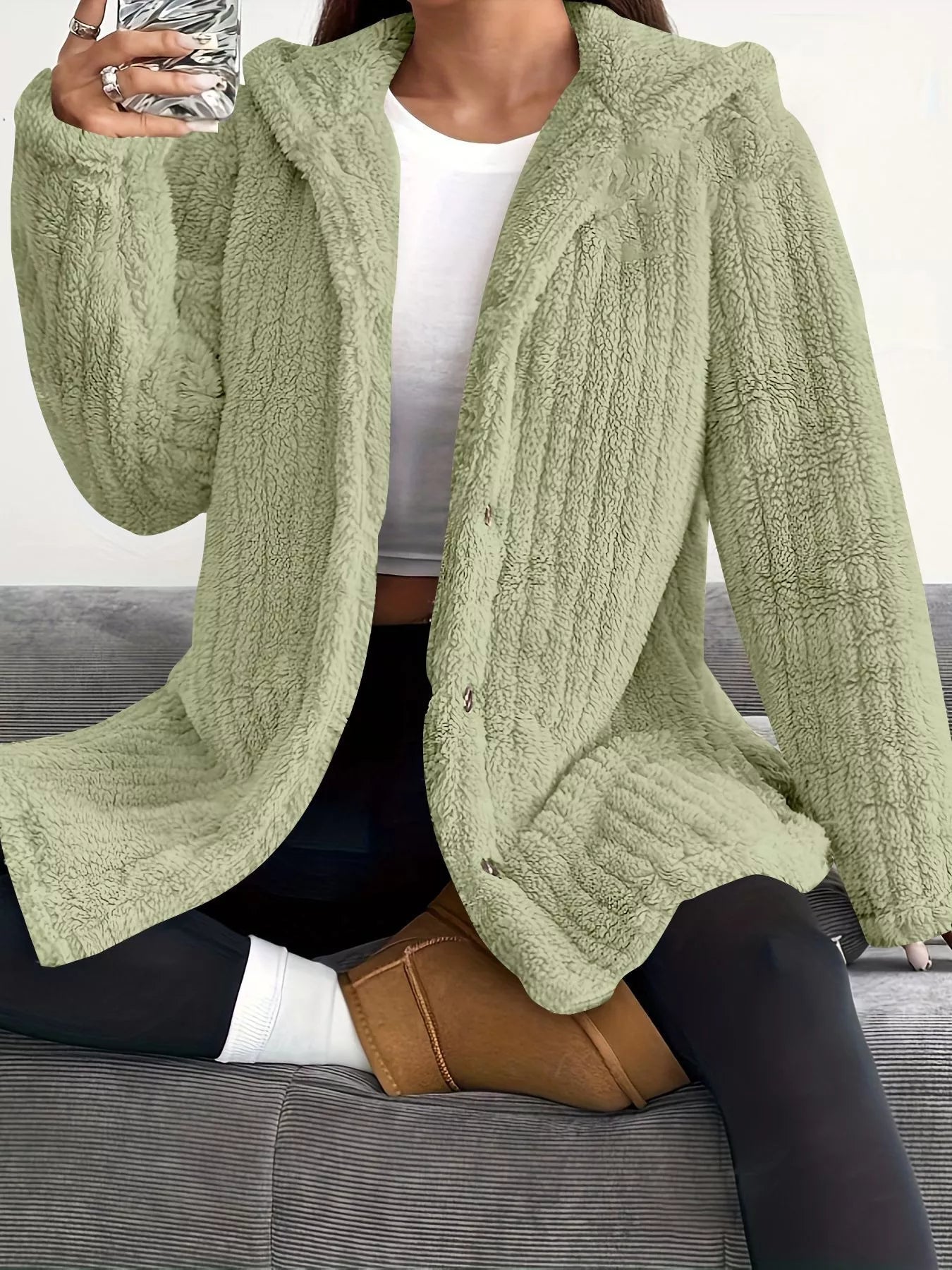 Green button-up fleece jacket with a cozy texture and hooded collar.