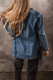Medium wash denim blazer with patch pockets and a double-breasted cut.