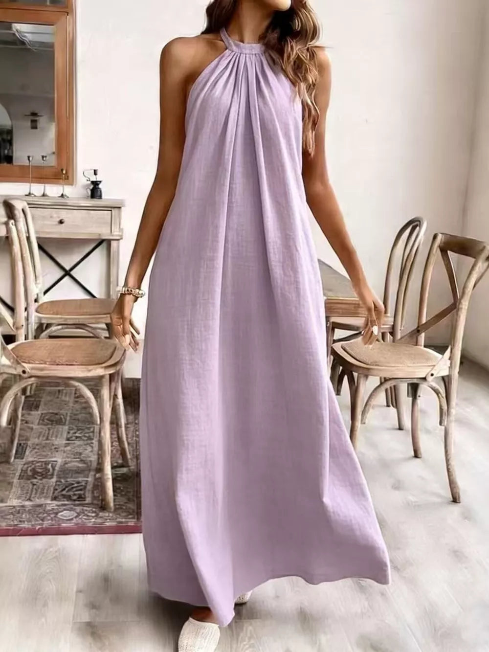 Light purple ruched halter maxi gown with a flowing skirt.
