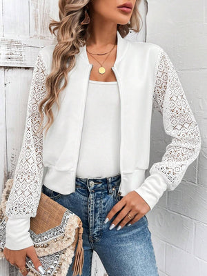 White bomber jacket with lace sleeves and zip front, styled with a white tank and jeans.