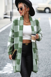 Oversized checkerboard knit duster coat in green and white with open front and pockets.
