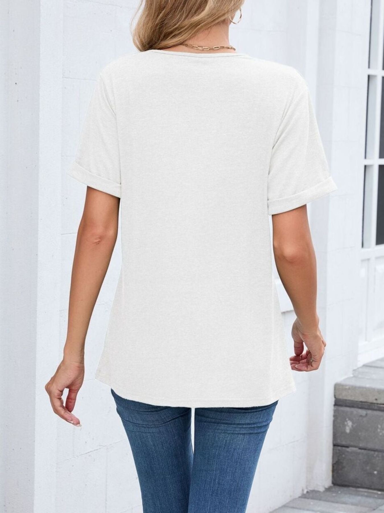 White V-neck t-shirt with cuffed short sleeves and a relaxed fit.
