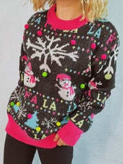 Black knit sweater with snowflake, snowman, and "Fa la la" print, embellished with colorful pom-poms.
