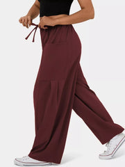 Burgundy maternity pants with adjustable drawstring and wide legs.