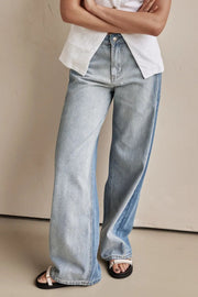 Panelled wide-leg denim trousers in light wash with contrast color blocking and a relaxed fit.